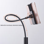 Black flexible ABS hose holder with a 360° adjustable clamp, securely holding a rose gold smartphone. Minimalist design.