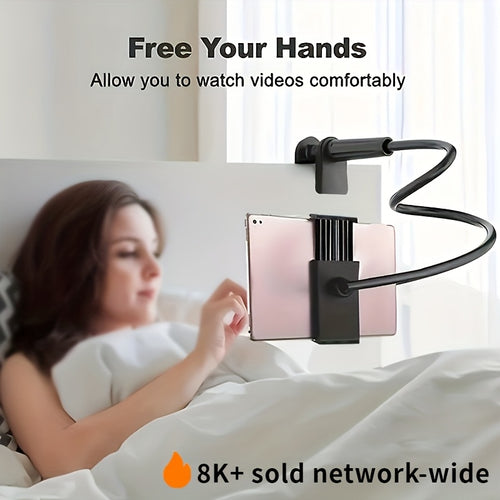 Black flexible gooseneck tablet and phone stand clamped to a white headboard, holding a rose gold tablet for hands-free viewing.